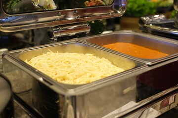 Close up of spaghetti pasta with red tomato sauce on a fork in box take away. Delicious Italian food delivery. selective focus.