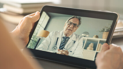 Doctor and patient talking on computer video call	