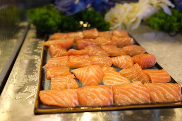 Traditional Norwegian smoked salmon in slices with lemon slices served as close-up on a Nordic design tray with text space . High quality photo