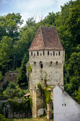 Scenic view of ancient tower with tiled roof in historical part of European city. Copy space. Selective focus.