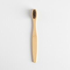 Bamboo toothbrush with soft bristles on a minimal white background  
