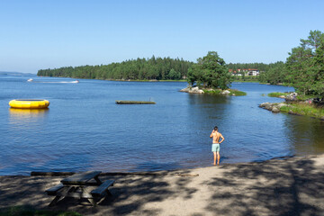 Fototapeta premium Tranquil Summer Beach by Rødenessjøen Lake in Ørje Norway