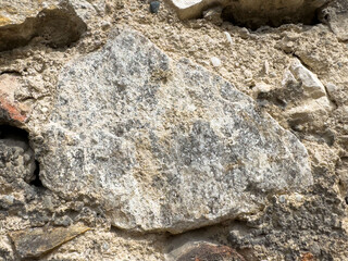 Close-up of ancient stone wall with weathered textures