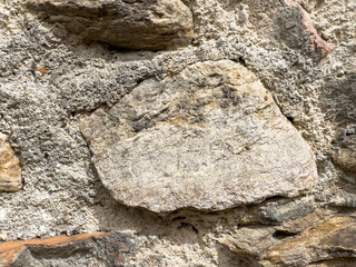 Close-up of rough textured stone wall surface