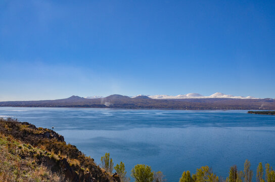 Lake Sevan and snow-covered Gegham ridge mountains scenic view from Sevanavank (Gegharkunik Province, Armenia)