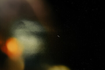 retro film overlay effect with scratch dust and light leaks,retro grain noisy film distressed texture light leak flare on black background