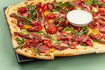 Closeup on pizza with bell pepper and smoked sausages