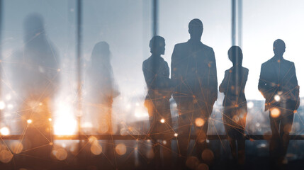 Silhouettes of business professionals standing together in office space, double exposure with digital network lines and glowing data nodes, concept of teamwork and technology