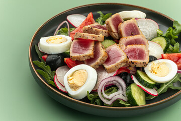 Portion of gourmet nicoise salad with tuna fish and eggs