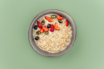 Portion of sweet breakfast oatmeal porridge with berries