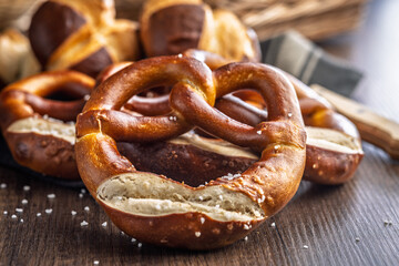 Salted bavarian pretzel on wooden table.