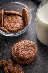 Sweet oatmeal cookies on black table.