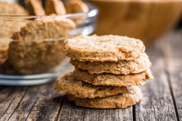 Sweet oatmeal cookies on wooden table.