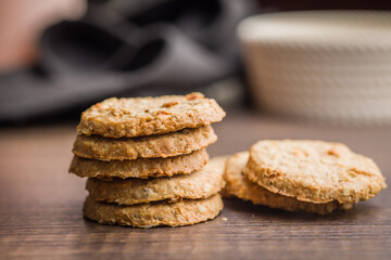 Sweet oatmeal cookies on wooden table.