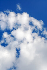 The sight of a blue sky adorned with fluffy white clouds in it