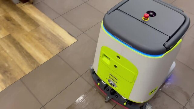 An autonomous cleaning robot moving across the shiny floor of the Vkusno i Tochka restaurant, emphasizing its modern technologies, Vkusno i tochka, Russia, Moscow, 05.05.2025 