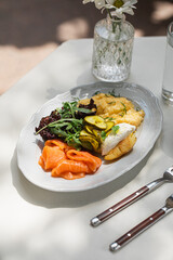 Portion of gourmet cafe breakfast with scramble and salmon