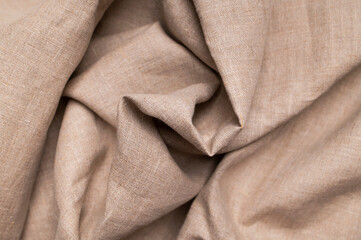 Natural beige brown linen fabric texture with folds and waves. Eco-friendly cotton material, fabric...