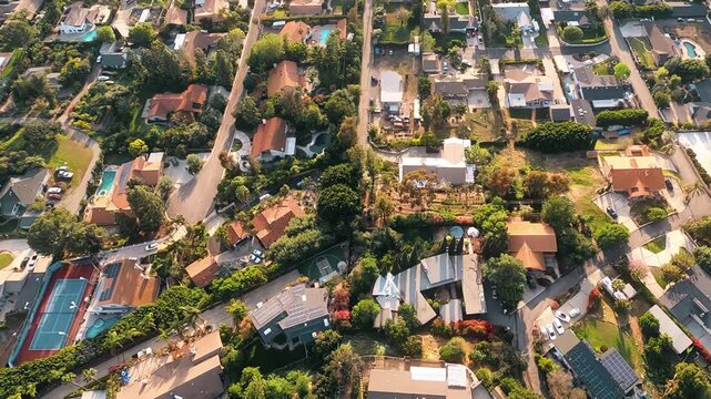 An aerial flyover view looking straight down on a typical Los Angeles, California area residential neighborhood. GoPro footage flown with FAA clearance by a licensed helicopter pilot. 