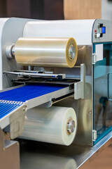 Roll of plastic film for automatic food packaging machine