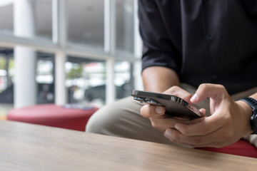 Man Using Smartphone Indoors in Business Casual Outfit