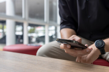 Man Using Smartphone Indoors in Business Casual Outfit