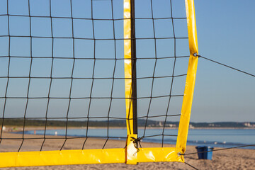 Volleyball yellow net on sand at beach. Sport and healthy lifestyles on fresh air. Vacation time