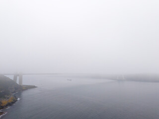Fototapeta premium Misty River View with Bridge. An aerial view of a river shrouded in fog or mist. Yavuz Sultan Selim Bridge Istanbul Turkey Turkiye Beykoz Poyrazkoy Turkey Turkiye Anatolian Side 