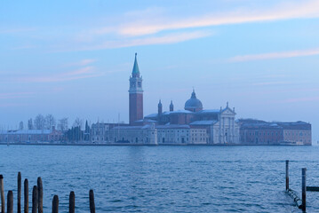 Fototapeta premium Chiesa di San Giorgio Maggiore during the blue hour in Venice. Dusk and light haze lies over the lagoon and gives the picture a calm atmosphere.