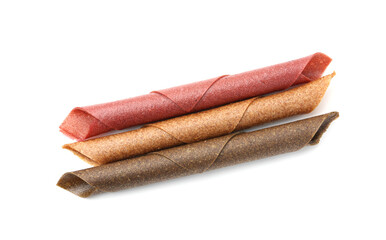 Delicious fruit leather rolls on white background, top view