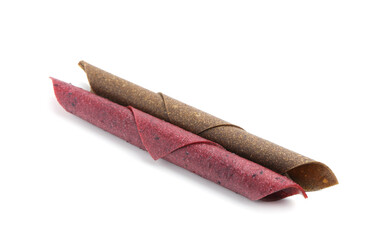 Delicious fruit leather rolls on white background
