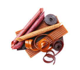Different delicious fruit leather on white background, top view