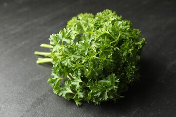 Bunch of fresh parsley on grey table, closeup