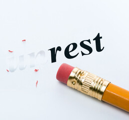 Word unrest rest and eraser close-up