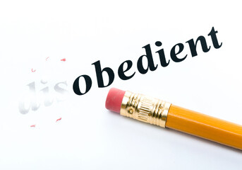 Word disobedient  obedient with eraser close-up