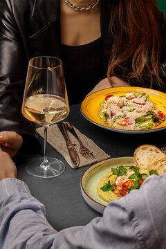 Couple enjoying romantic dinner with wine and gourmet food
