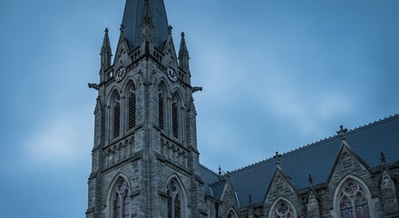 Gothic church tower against a muted sky