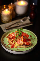 Delicious bruschetta with bacon, cheese and tomatoes, garnished with microgreens on romantic dinner table