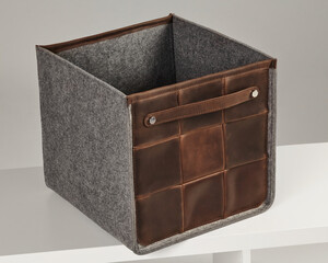 Empty leather and felt storage box sitting on shelf