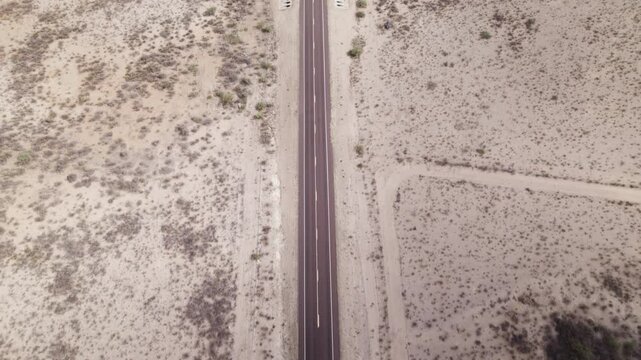 Aerial view of a solo vehicle on an empty stretch of desert highway near Big Bend in west Texas
