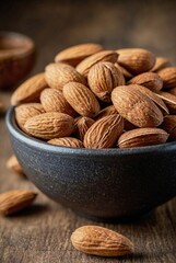bowl filled with whole almonds. Nuts are a source of healthy fats and vitamins	
