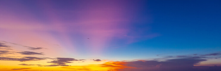 beautiful colourful sunset on Kuta Beach on the island of Bali blue purple orange skies with turquoise blue waters and silhouette of people on the sandy beach the land of gods Bali Island Indonesia  