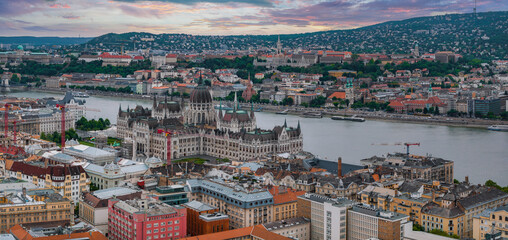 Aerial view of Budapest, Hungary, featuring the Hungarian Parliament Building by the Danube River,...