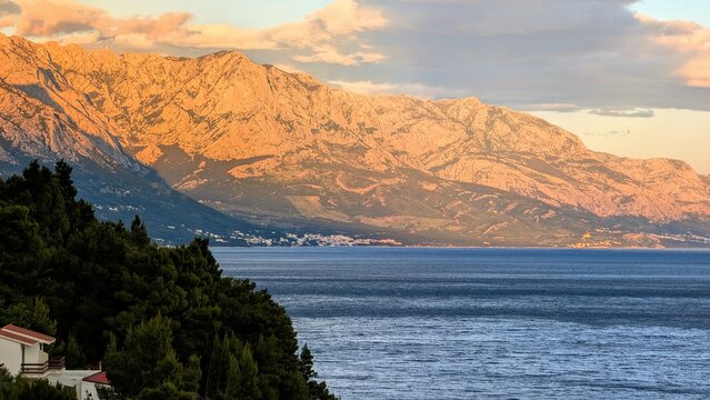 Beautiful coastal landscape scenery, Mimice village near Split city with mountain Biokovo in background, Crroatia, travel and nature