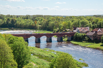 View to the Venta rapid and bridge from view tower in Kuldiga on a sunny day in May in Latvia