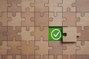 A wooden puzzle symbolizes strategic decision-making and problem solving in business revealing a check mark as a sign successful completion and achieved goals
