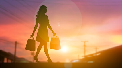Woman holding shopping bag silhouette sunset time