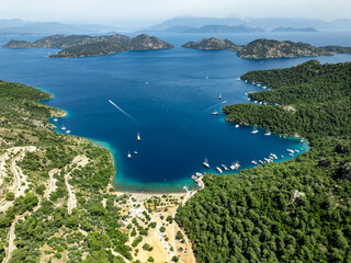 Sailing boats navigating the turquoise waters of Sarsala Bay in Dalaman, Turkey