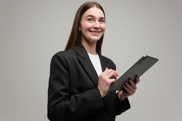 Young professional in a suit confidently interacts with a tablet in a modern studio setting