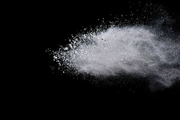 White powder or flour explosion isolated on black background.